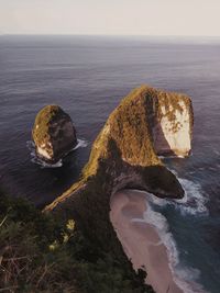 Scenic view of rocks on sea against sky