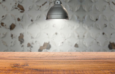 Close-up of illuminated light bulb on wall