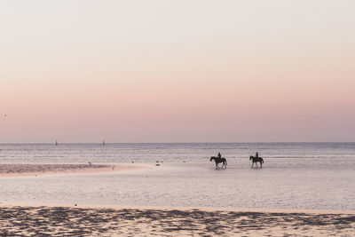 Scenic view of sea against clear sky during sunset