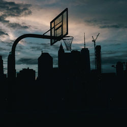 Low angle view of silhouette buildings against sky during sunset