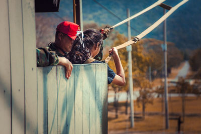 Man preparing girl for bungee jumping