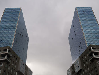 Low angle view of modern buildings against sky in city. bilbao, spain