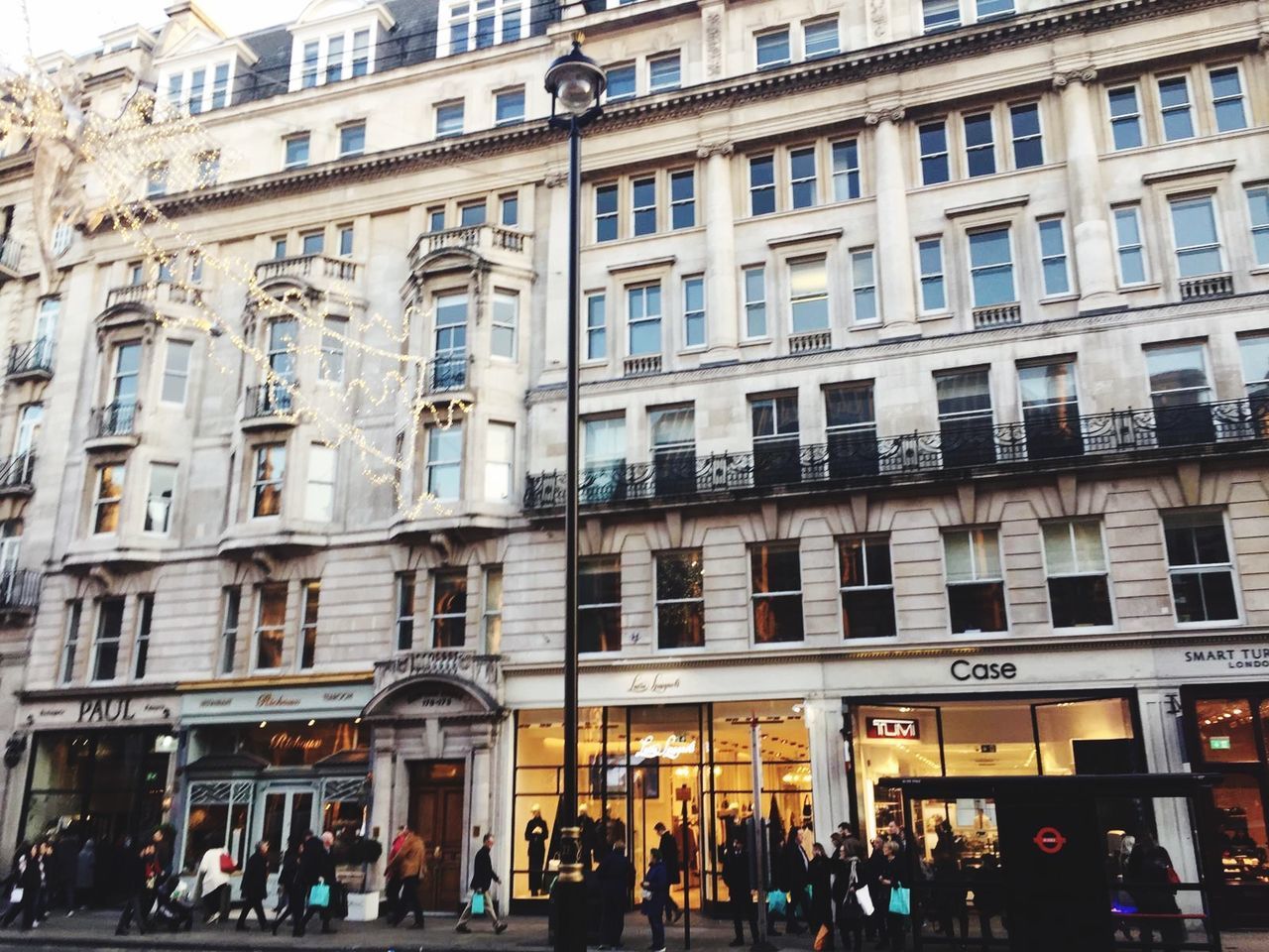 PEOPLE ON STREET AGAINST BUILDINGS IN CITY