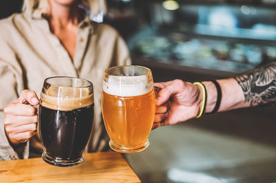 Midsection of woman drinking glass