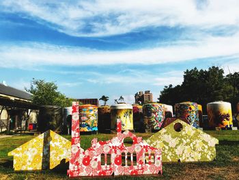 Multi colored plants in cemetery against sky