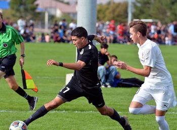 Men playing with people on field