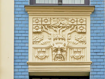 Close-up of sculptures on wall of building