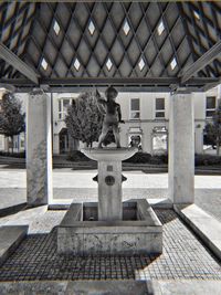 Statue against building