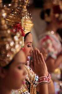 Person holding sparkler in front of wall