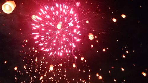 Low angle view of firework display at night