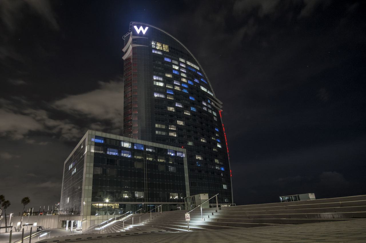 LOW ANGLE VIEW OF ILLUMINATED BUILDING AGAINST SKY