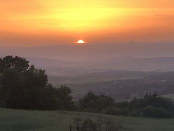 Scenic view of landscape against sky during sunset