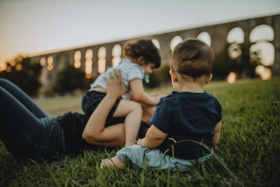 Mother with son and daughter on grass