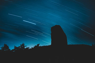 Low angle view of silhouette trees against sky at night
