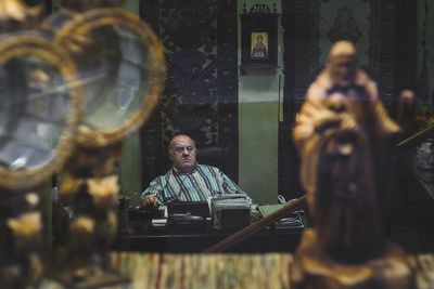 Reflection of man on glass window