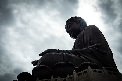 Low angle view of statue against cloudy sky