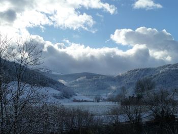 Scenic view of frozen river against sky