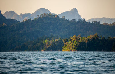 Scenic view of sea and mountains against sky