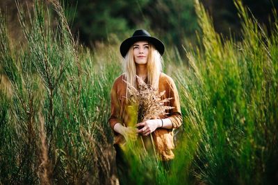 Portrait of woman standing on field