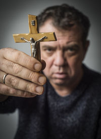 Close-up portrait of man holding camera