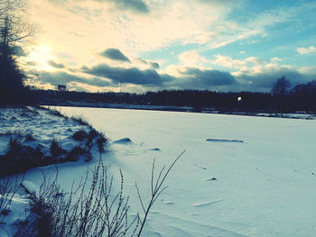 Scenic view of frozen lake against sky during winter