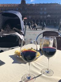 Wine glasses on table in city