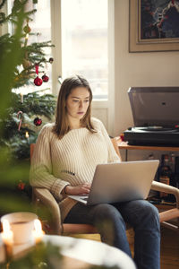 Woman using laptop in living room