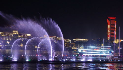 Illuminated city buildings at night