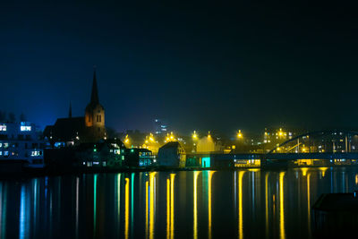 View of illuminated cityscape against sky at night