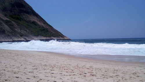 Scenic view of beach against clear sky