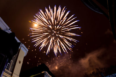 Low angle view of firework display at night