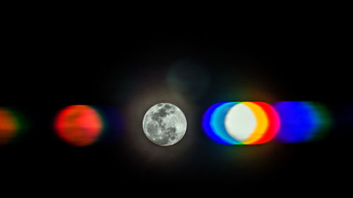 Close-up of illuminated lights against black background