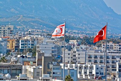 Flag in city against sky