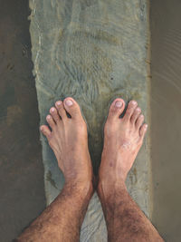 Low section of woman standing on beach