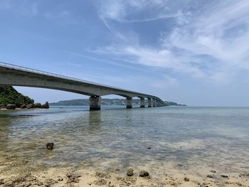 Bridge over sea against sky