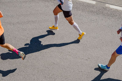 Low section of people walking on road