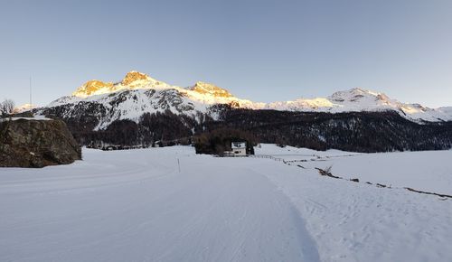 Scenic view of snowcapped mountains against clear sky