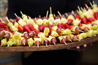 Close-up of man holding fruits in tray