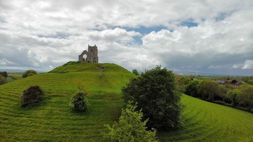 Built structure on landscape against sky