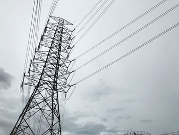 Low angle view of electricity pylon against sky