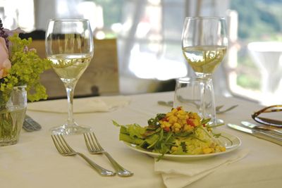 Close-up of food and wine served on table in restaurant