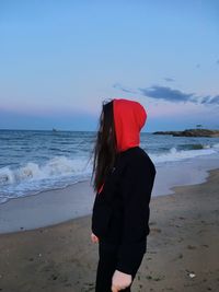 Rear view of man standing on beach