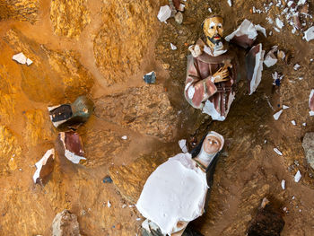 High angle view of people sitting on rock