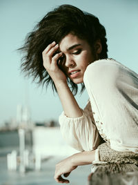 Portrait of a young woman sitting outdoors