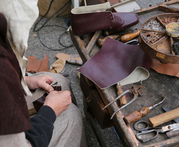 Midsection of manual worker working at workshop
