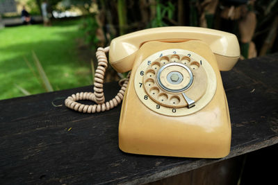 Close-up of old telephone on table