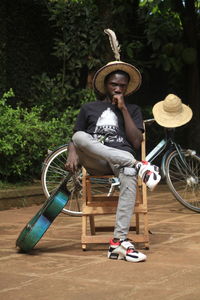 Full length portrait of smiling man riding bicycle