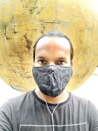 Close-up portrait of young man against wall