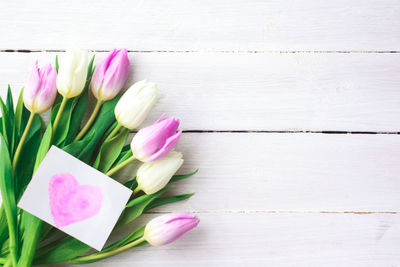 High angle view of pink tulip on table