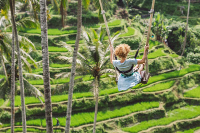 Rear view of a woman on a swing 